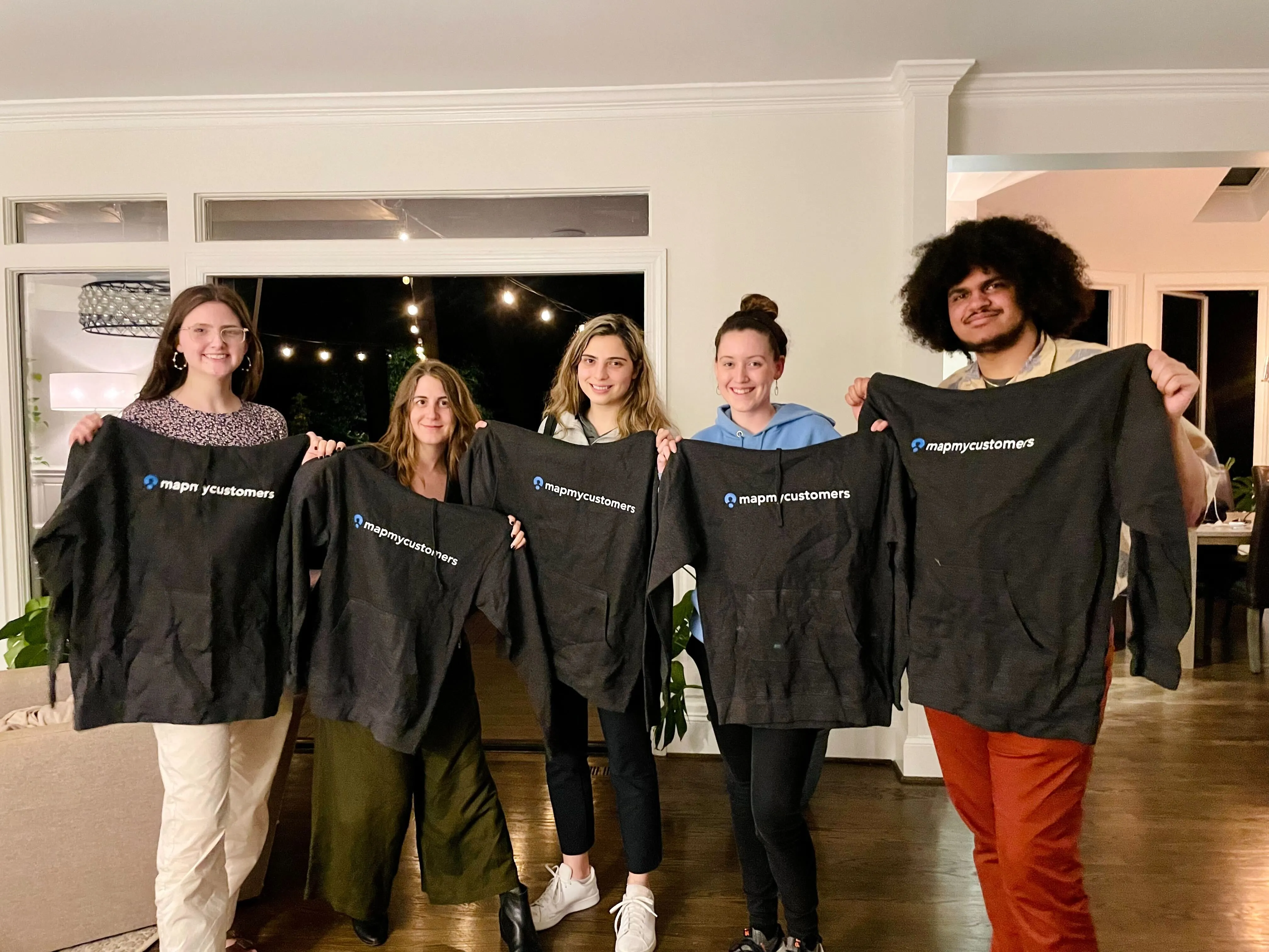 Team showing off Map My Customers swag