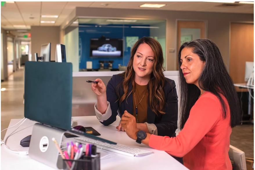 Saleswoman with a computer talks to a client in a hospital setting