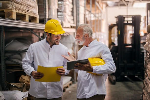 Two men in a warehouse having a sales conversation