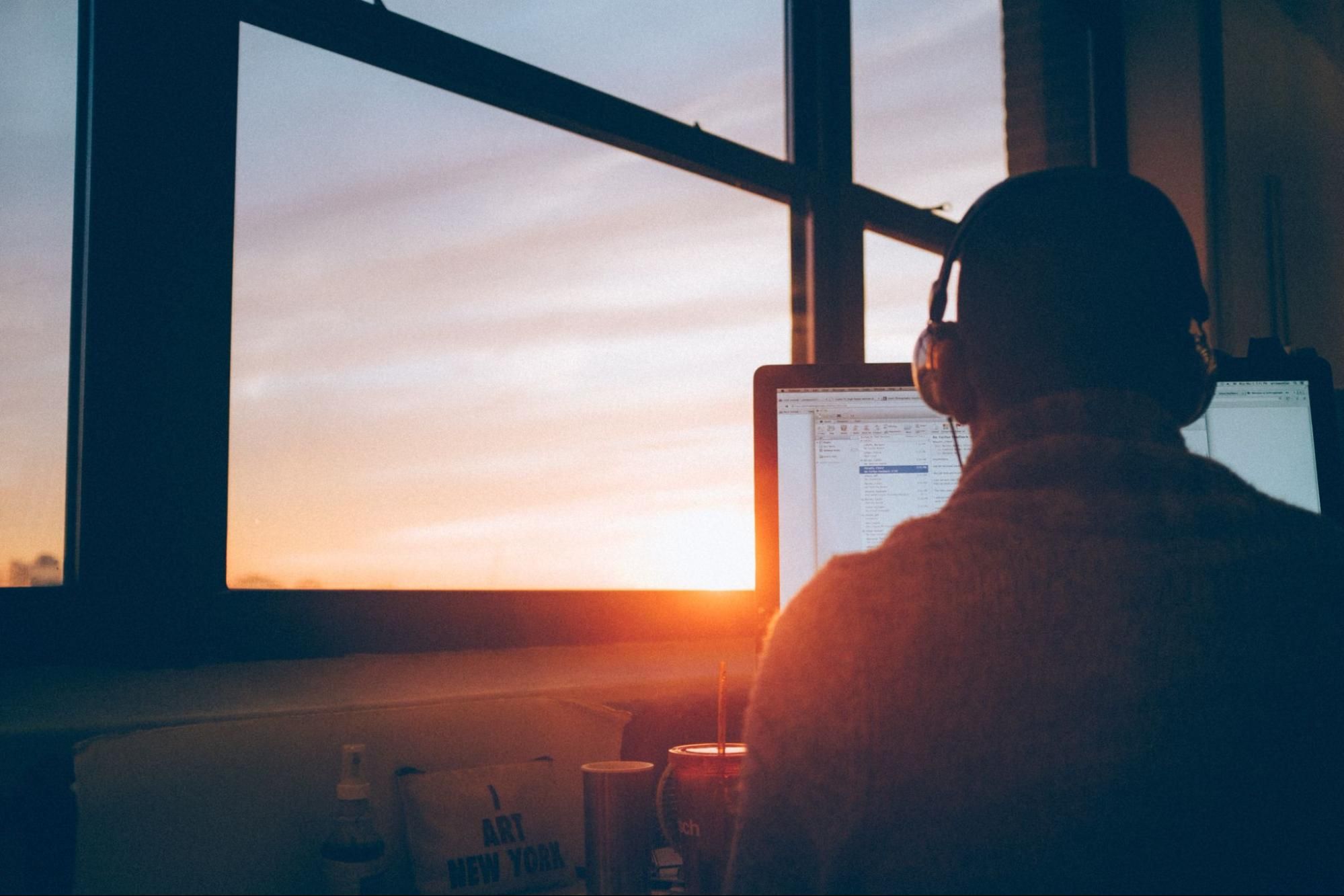 Man with headphones sitting in front of a computer