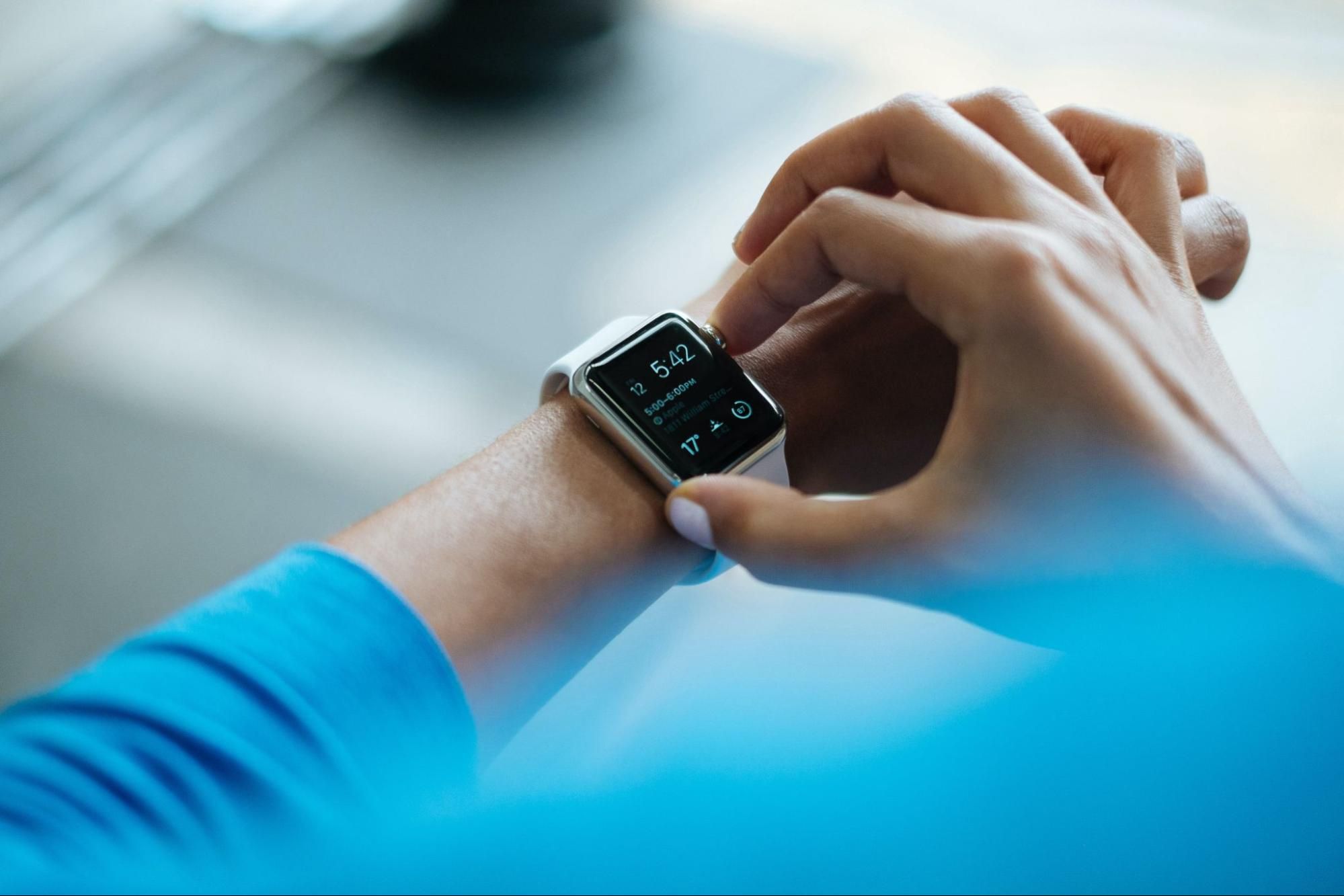 Woman checking smartwatch for time management