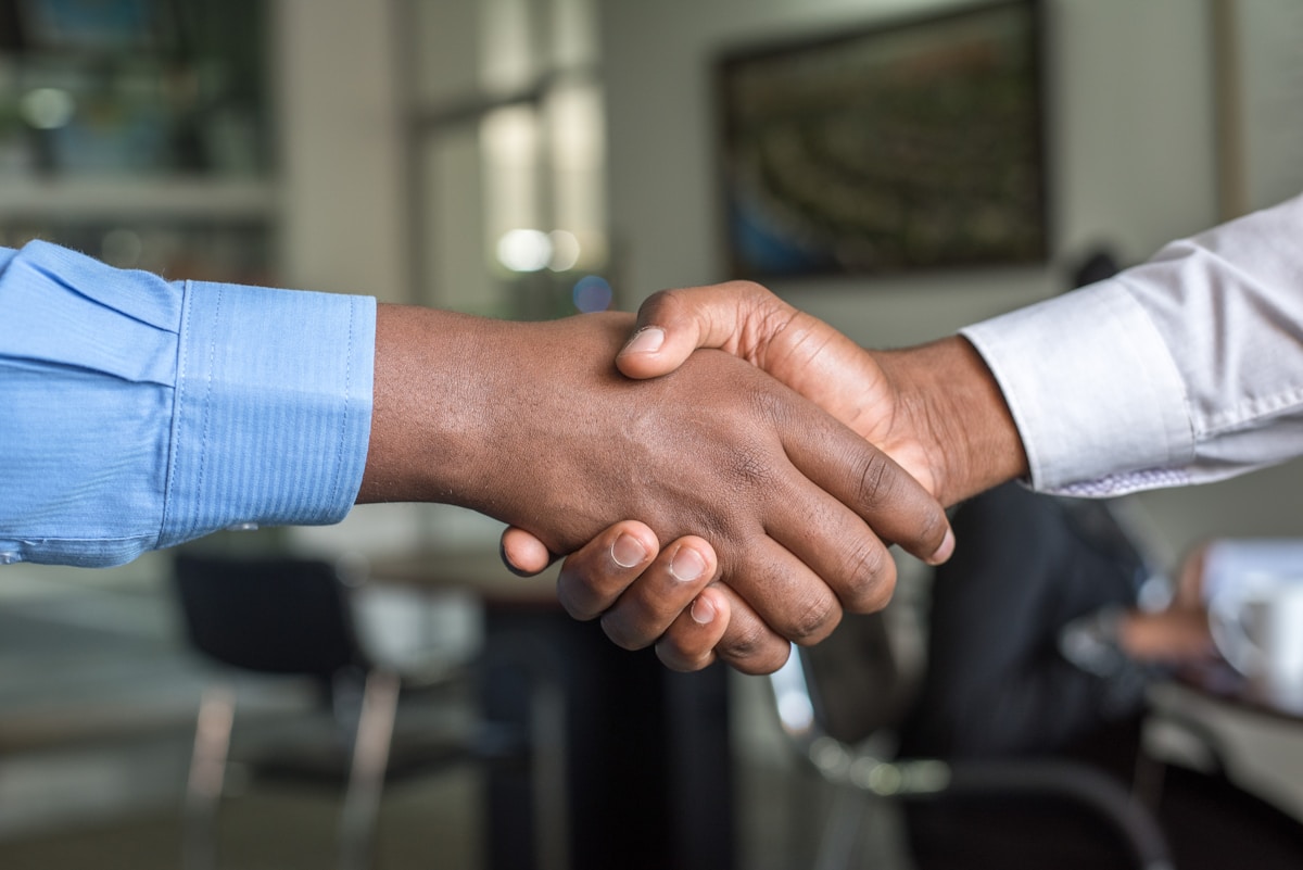Two businessmen shaking hands after a successful sales pitch